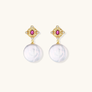Gold baroque pearl earrings with pink gemstone studs and ornate detailing on cream background.